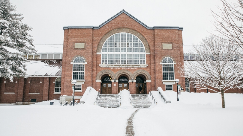 The front of Alumni Gym covered in snow.