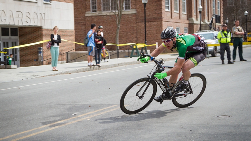 A cyclist rounds a corner during a race.