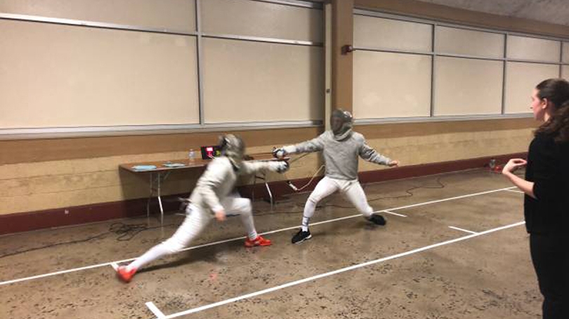 Two fencers compete.