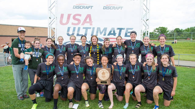 The women's ultimate frisbee team poses for a picture.